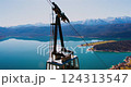 Ride on a cable car offering breathtaking views of the lake and mountains during a sunny day 124313547