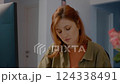 Frustrated woman working at home office desk with papers and computer 124338491