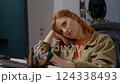 Woman shows boredom while working in home office setting 124338493