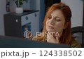 Woman in home office struggling with neck pain while working on computer 124338502