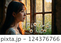 Young Woman in White Dress Gazing Out Rustic Window at Sunset 124376766