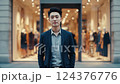 Portrait of Young Man in Blue Blazer Outside City Storefront at Dusk 124376776