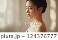 Portrait of a Young Woman with Soft Lighting and Sheer White Background 124376777