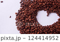 A creative arrangement of roasted coffee beans forming a heart shape on a clean white background, showcasing the beauty and texture of coffee in modern food  124414952