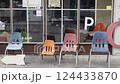 Four chairs lined up in front of a store 124433870