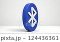 A 3D rendered Bluetooth emblem with a white icon on a blue, circular surface, representing wireless communication and digital technology. 124436361