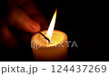 The first candle is lit in one hand for comfort, and the second candle is lit, and then the first candle burns out. 124437269