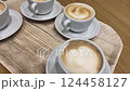 Top-Down View of a Tray with Four Cappuccinos on a Table 124458127