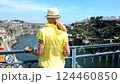 Blonde girl stands on the bridge and looks at the river 124460850