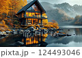 Tranquil lakeside cabin retreat amidst autumn forest reflections at dusk 124493046