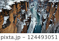 Drone flight over snowcapped canyon with icy river and scenic winter views 124493051