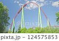 Roller coaster Ride against blue sky. Roller coaster in the amusement park. Cheerful entertainments in park of attractions 124575853