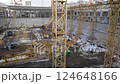 Progress at the construction site featuring cranes, equipment, and machinery 124648166