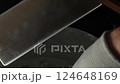 Combining a White Substance Using a Metal Spatula for Better Mixing 124648169
