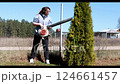 Using a leaf blower for yard maintenance during sunny spring day in the countryside 124661457