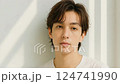 Handsome man brushing his hair back 124741990