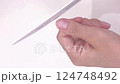Shaping your nails with an emery board 124748492