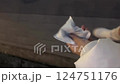 The feet of a woman walking at night with a hot pack 124751176