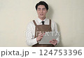 A Japanese man in an apron giving an explanation 124753396