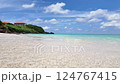 Scenic View Of A Tranquil Beach With Clear Blue Water And A Partly Cloudy Sky 124767415