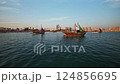 Doha, Qatar - November 24 2022: Katara Twelfth traditional dhow festival in Doha Qatar afternoon shot showing Traditional dhows in Arabic gulf with flags of countries of FIFA Word cup 2022  124856695