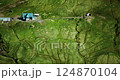Green hills with farmland and rustic buildings in highland region 124870104