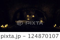 Shadows and candlelight in an ancient underground chamber 124870107