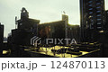 Urban rooftop with radio antennas and large billboard under bright sky 124870113