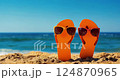 Yellow flip flops on sandy ocean tropical beach with sea wave and blue sky 124870965