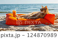 cat in sunglasses relaxing lying on inflatable mattress with juicy cocktail 124870989