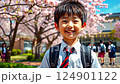 little asian kid in school uniform with backpack on school background, smiling japanese boy on street, chinese teenager, korean student, child 124901122