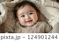 little cute smiling korean baby lying in crib, infant in cradle, asian child, kid, chinese newborn, childhood 124901244