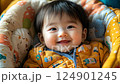 little cute smiling korean baby lying in crib, infant in cradle, asian child, kid, chinese newborn, childhood 124901245