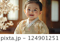 little smiling korean child in beige clothes on room background, happy asian toddler, cute baby wearing traditional kimono 124901251