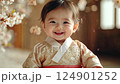 little smiling korean child in beige clothes on room background, happy asian toddler, cute baby wearing traditional kimono 124901252
