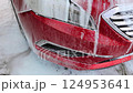 Close-up of car wash foam on headlights. cleaning the car from dirt. 124953641