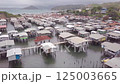 Aerial drone shot of Hanuabada village in Capital City Port Moresby, Papua New Guinea. Koki Stilt village. Motu tribe. Plenty of garbage everywhere. High quality 4k footage 125003665