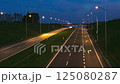 Illuminated Highway at Night with Motion Light Trails of Passing Vehicles 125080287
