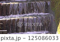 A river flowing smoothly down the stone steps 125086033
