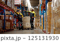 Warehouse workers are inspecting goods inside the warehouse. 125131930