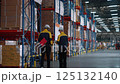 Warehouse workers are inspecting goods inside the warehouse. 125132140