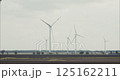 Wind turbines rotating in cloudy day generating green energy 125162211