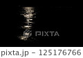 Soft moonlight glimmers across the dark rippling surface of the sea, creating a serene path of light in the peaceful night 125176766