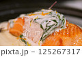 Chef spreads sauce on salmon. Slow motion. 125267317