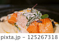 Chef spreads sauce on salmon. Slow motion. 125267318
