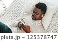 Sleepy tired man chatting in smartphone. 125378747