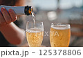 man pouring champagne in glasses closeup 125378806