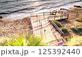 Sunrise Over Long Beach: Weathered Steps and Soft Waves Embracing the Sandy Shore in Iskele, Northern Cyprus 125392440