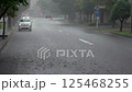 Raindrops create small circles, covering the entire street.AI Generated 125468255