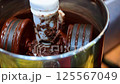 Cocoa beans and roasted Cocoa beans roasting in roaster coco beans machine to make cacao liquor at coco shop cafe or restaurant 125567049